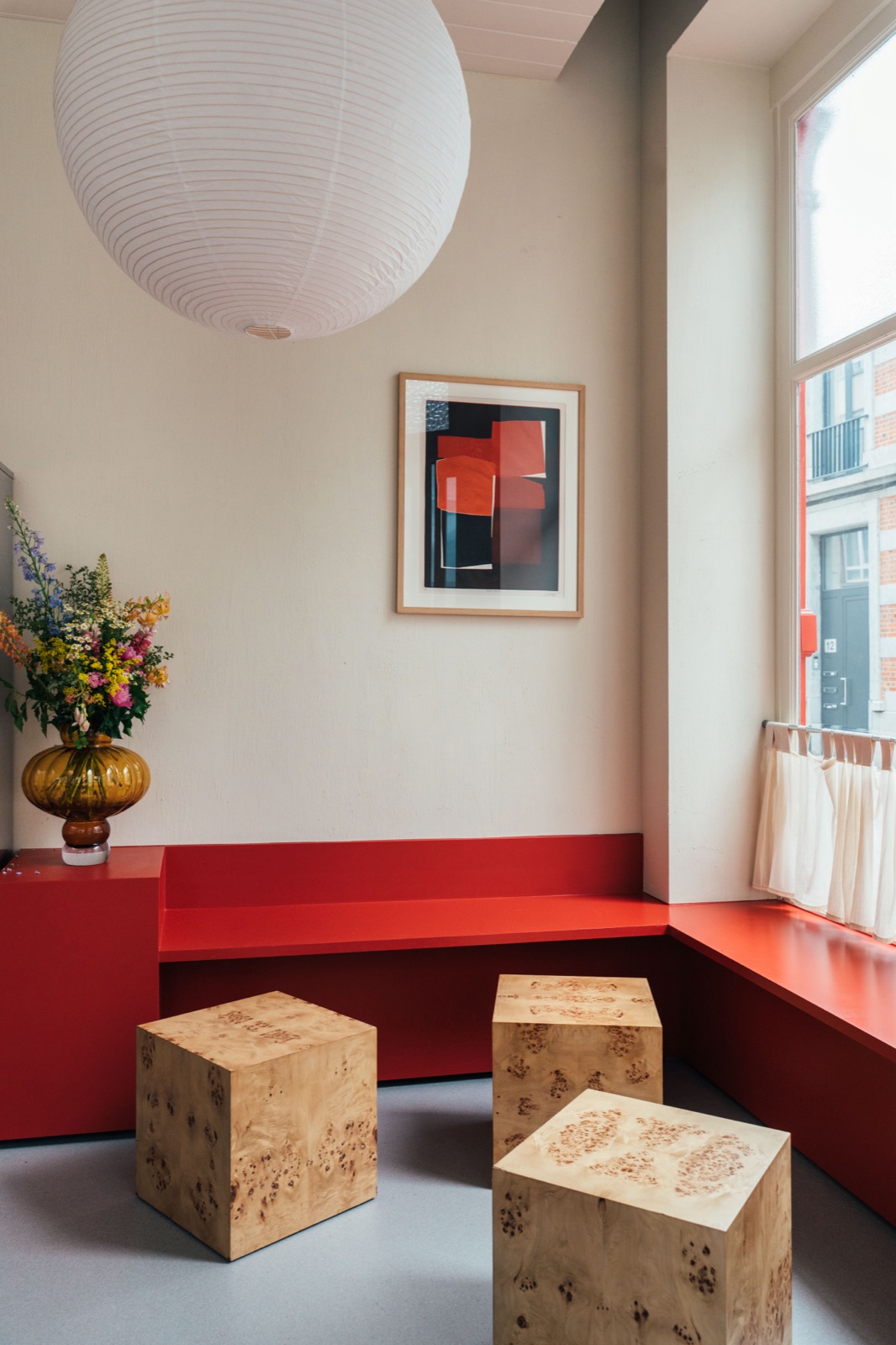Red bench and wooden stools inside Eight