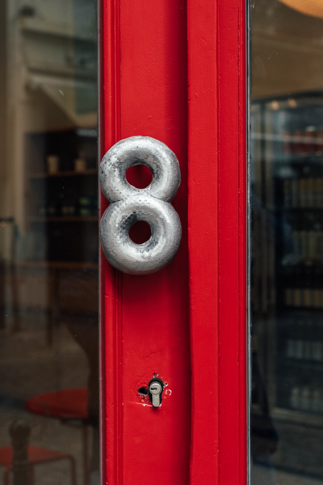 The red door of Eight with its number 8